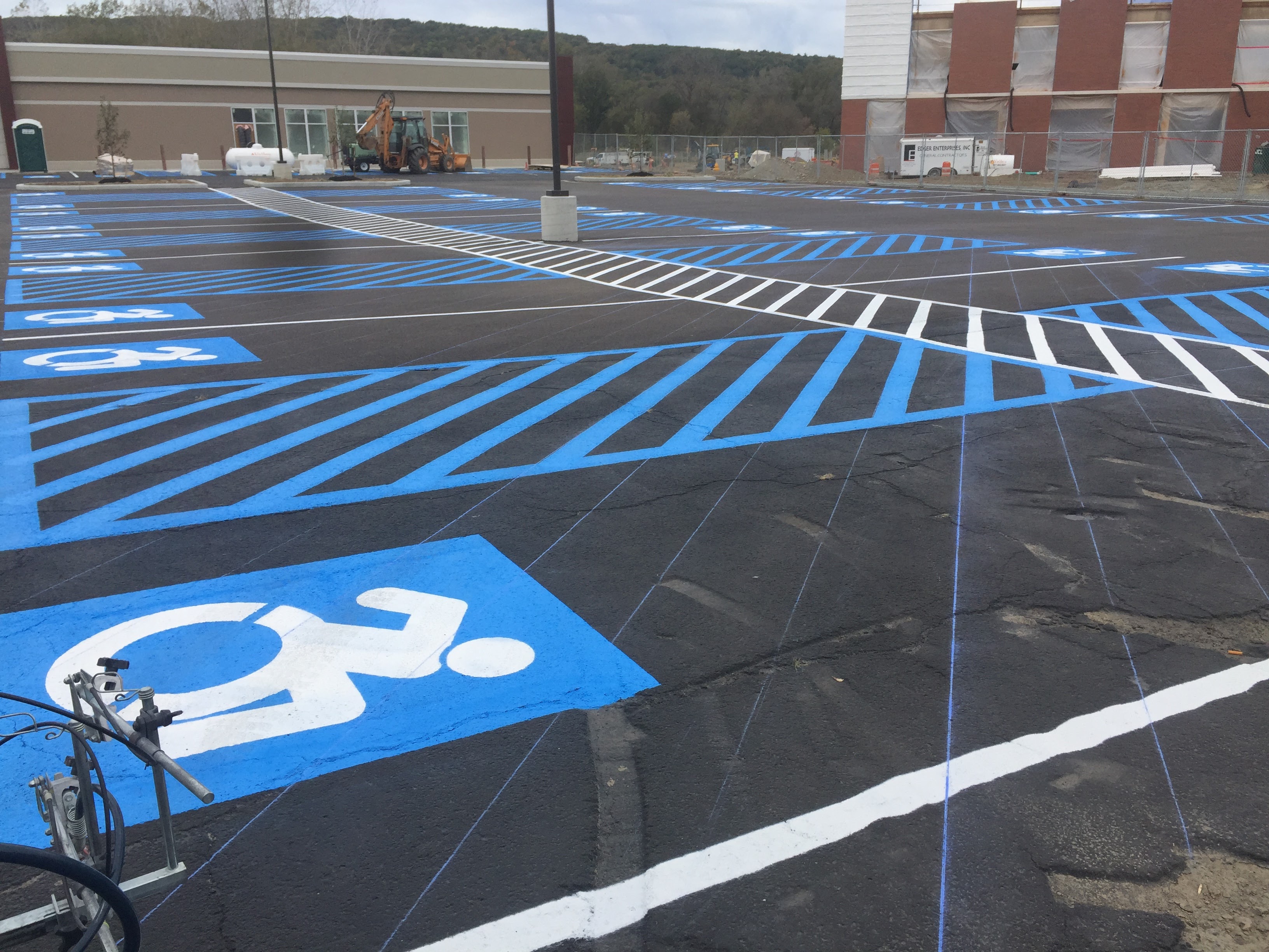 Freshly painted ADA parking stalls on black asphalt